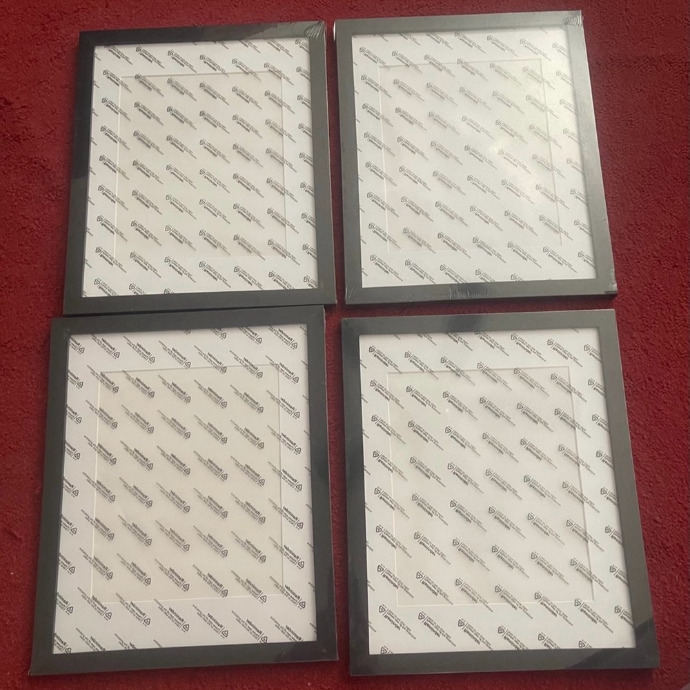 Set of 4 11 by 14 Black Picture Frames but matted to fit a eight by ten photo.